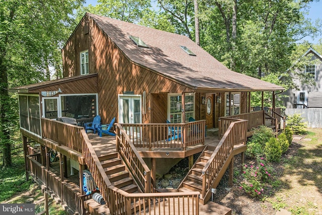 rear view of property featuring stairway, roof with shingles, french doors, and a deck
