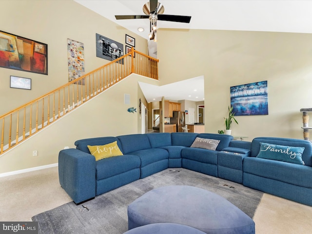 109 Galyn Dr, Brunswick, MD 21758 - living room featuring carpet flooring, stairs, ceiling fan, a towering ceiling, and baseboards
