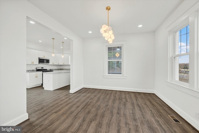 1127 Chesaco Ave, Rosedale, MD 21237 - unfurnished dining area with healthy amount of natural light, dark wood finished floors, baseboards, and recessed lighting