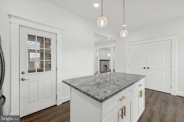 1127 Chesaco Ave, Rosedale, MD 21237 - kitchen featuring light stone counters, dark wood finished floors, baseboards, pendant lighting, and a kitchen island