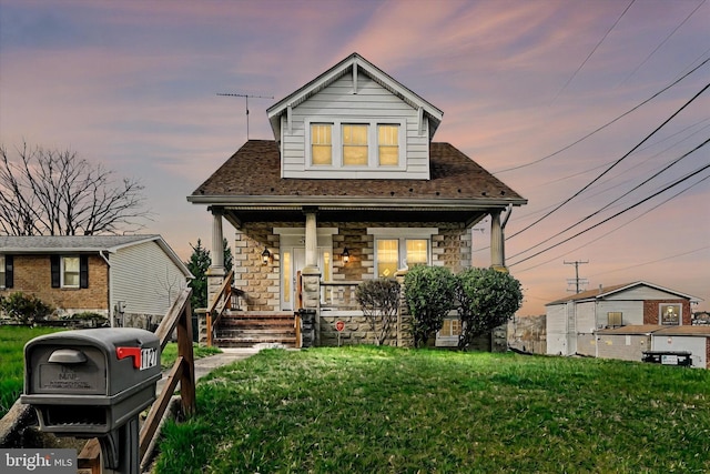 1127 Chesaco Ave, Rosedale, MD 21237 - view of front facade featuring a porch, stone siding, and a front lawn