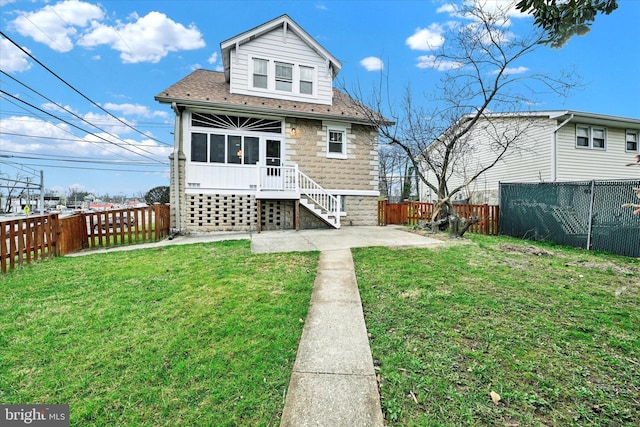 1127 Chesaco Ave, Rosedale, MD 21237 - back of property featuring a shingled roof, a patio area, and a sunroom