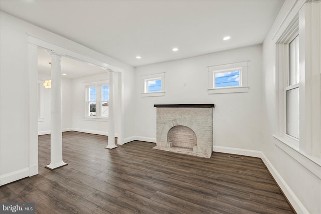 1127 Chesaco Ave, Rosedale, MD 21237 - unfurnished living room featuring dark wood-style flooring, baseboards, decorative columns, recessed lighting, and a fireplace with flush hearth