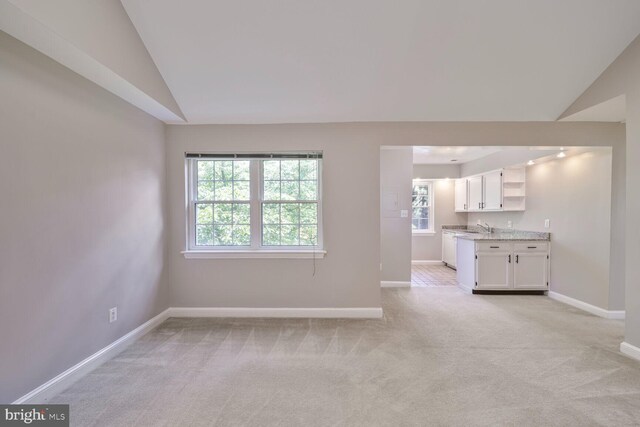 2101 N Taft St Unit 123, Arlington, VA 22201 - unfurnished living room featuring lofted ceiling and light carpet