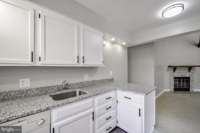2101 N Taft St Unit 123, Arlington, VA 22201 - kitchen featuring dishwasher, white cabinets, carpet floors, a peninsula, and light stone countertops