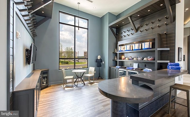 office space featuring plenty of natural light, light wood-type flooring, baseboards, and built in shelves