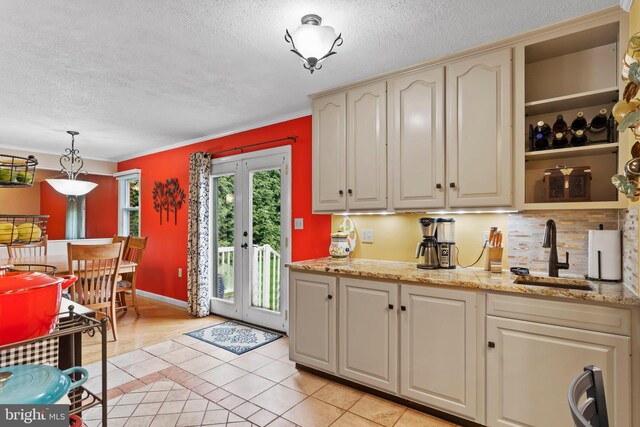 115 Diller Rd, New Cumberland, PA 17070 - kitchen with a sink, a textured ceiling, light tile patterned flooring, open shelves, and decorative backsplash