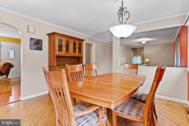115 Diller Rd, New Cumberland, PA 17070 - dining room with arched walkways, baseboards, light wood-type flooring, and crown molding