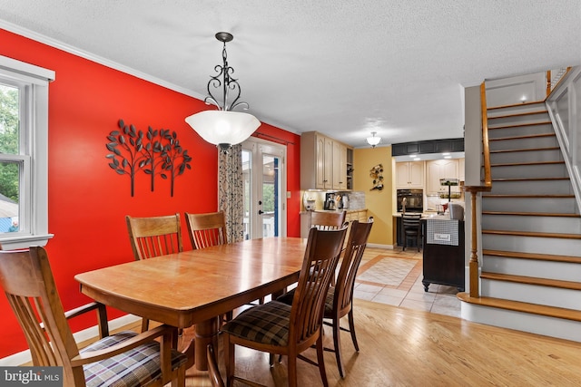 115 Diller Rd, New Cumberland, PA 17070 - dining room with stairway, a textured ceiling, light tile patterned flooring, ornamental molding, and baseboards