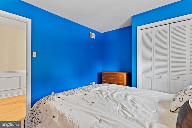 115 Diller Rd, New Cumberland, PA 17070 - unfurnished bedroom featuring a closet, wood finished floors, and wainscoting