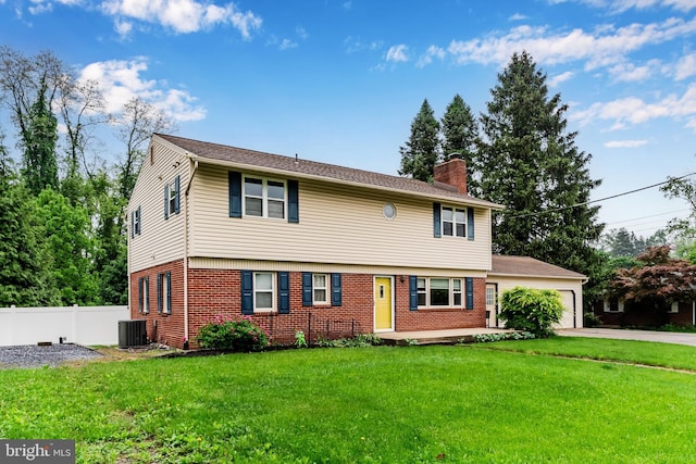 115 Diller Rd, New Cumberland, PA 17070 - colonial house featuring a chimney, central AC unit, brick siding, a garage, and driveway