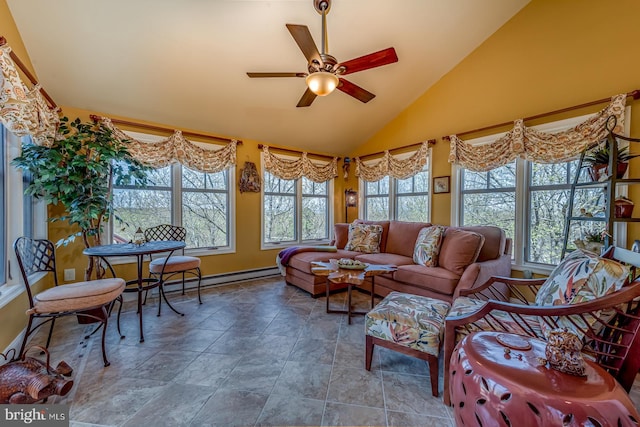 sunroom featuring healthy amount of natural light, stone finish flooring, baseboards, a baseboard radiator, and high vaulted ceiling