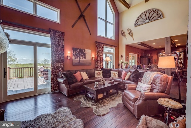 living room with a towering ceiling and hardwood / wood-style floors