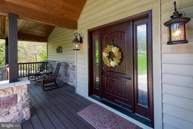 view of exterior entry with a porch