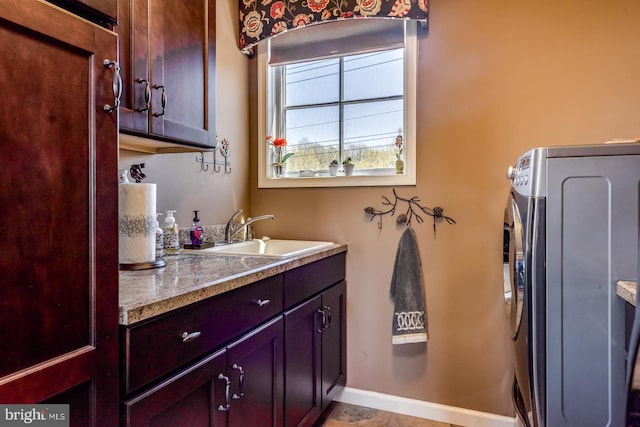 bathroom featuring washer / clothes dryer, baseboards, and vanity