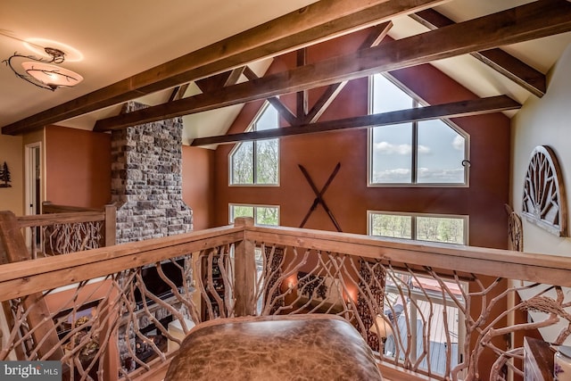 staircase with beamed ceiling and high vaulted ceiling