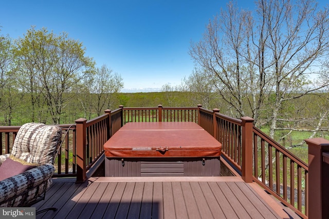 deck featuring a covered hot tub
