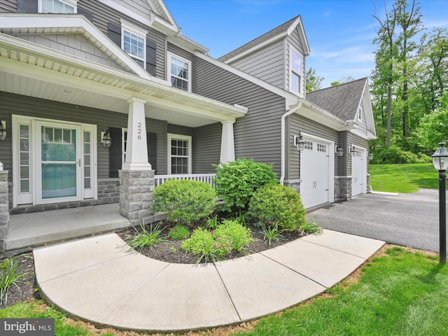 226 Crimson Ln, Elizabethtown, PA 17022 - view of home's exterior with covered porch, asphalt driveway, an attached garage, stone siding, and a shingled roof