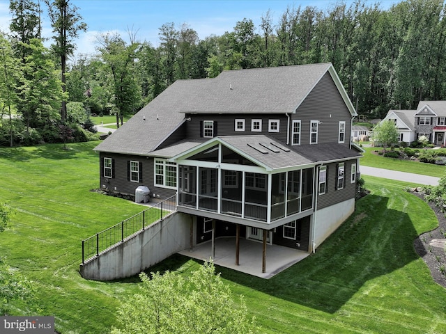 226 Crimson Ln, Elizabethtown, PA 17022 - back of house featuring a sunroom, a patio, roof with shingles, and a lawn