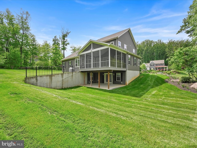 226 Crimson Ln, Elizabethtown, PA 17022 - rear view of house featuring a sunroom, a patio area, and a lawn