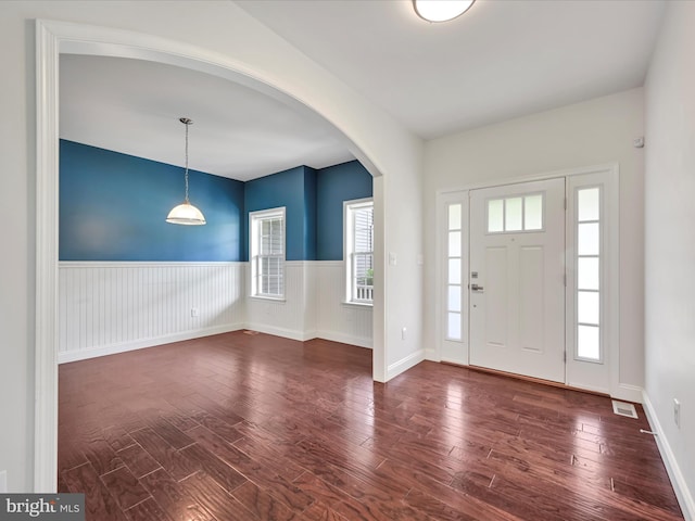 226 Crimson Ln, Elizabethtown, PA 17022 - foyer featuring dark wood-style floors, arched walkways, wainscoting, and baseboards