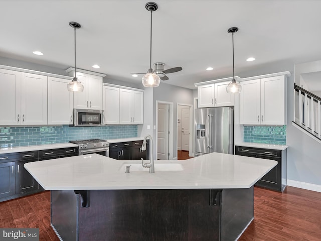 226 Crimson Ln, Elizabethtown, PA 17022 - kitchen with high quality appliances, a sink, white cabinetry, tasteful backsplash, and dark wood-style flooring