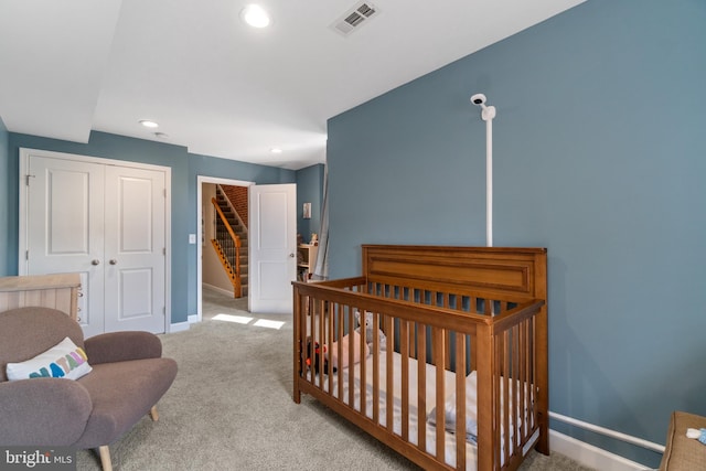 bedroom with carpet floors, baseboards, a closet, recessed lighting, and a nursery area
