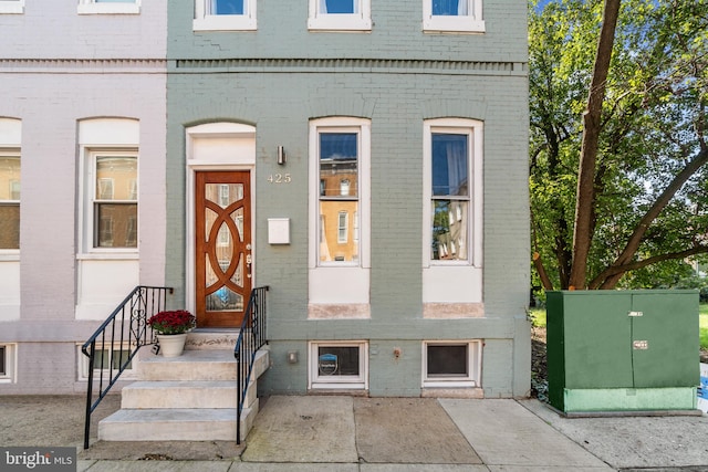 doorway to property with brick siding