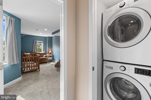 washroom featuring stacked washer / drying machine, carpet floors, baseboards, and recessed lighting