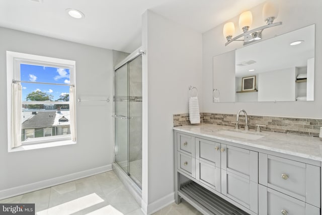 full bath featuring baseboards, backsplash, a stall shower, vanity, and recessed lighting