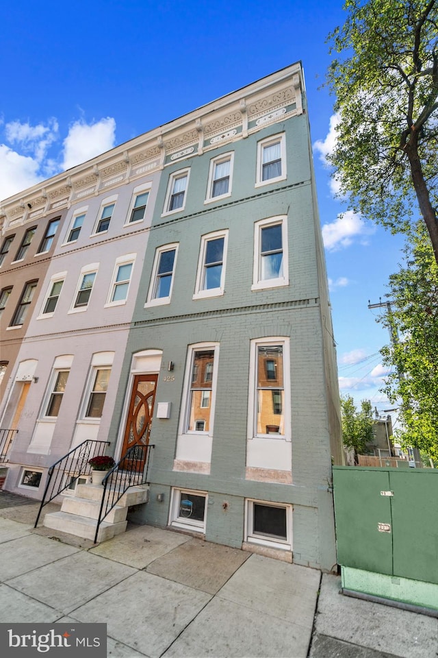 townhome / multi-family property with brick siding