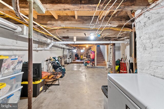 unfinished basement featuring stairs