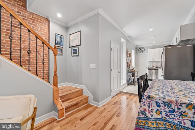 dining space with baseboards, light wood-style flooring, stairs, ornamental molding, and recessed lighting