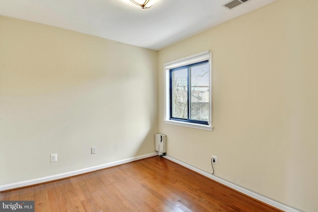146 Monroe St Unit 101, Rockville, MD 20850 - unfurnished room with wood finished floors, baseboards, and radiator