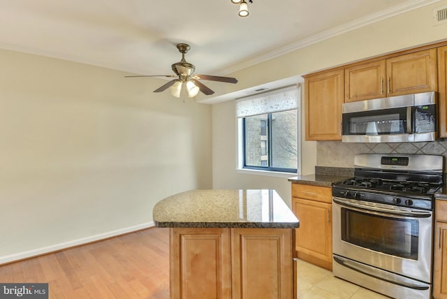 146 Monroe St Unit 101, Rockville, MD 20850 - kitchen with stainless steel appliances, backsplash, a ceiling fan, a kitchen island, and dark stone counters