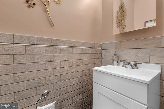 702 N Arlington Ave, Baltimore, MD 21217 - bathroom featuring tile walls, vanity, and a wainscoted wall