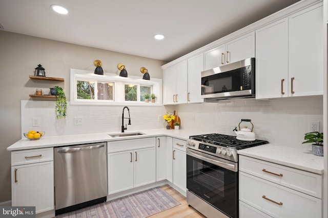 702 Lupin St, Browns Mills, NJ 08015 - kitchen with stainless steel appliances, a sink, white cabinets, backsplash, and open shelves