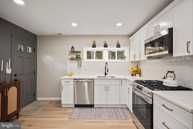 702 Lupin St, Browns Mills, NJ 08015 - kitchen with stainless steel appliances, a sink, decorative backsplash, white cabinetry, and recessed lighting