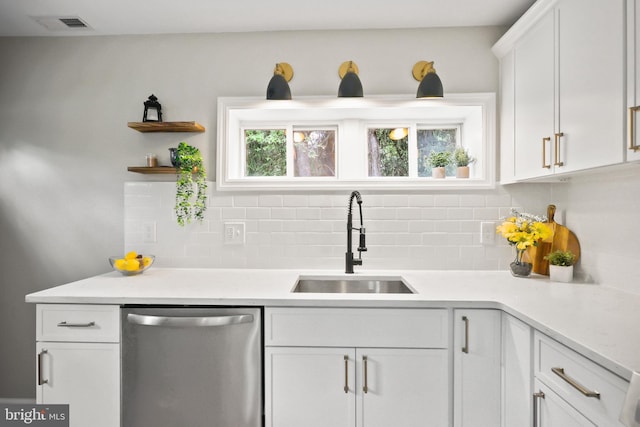 702 Lupin St, Browns Mills, NJ 08015 - kitchen featuring dishwasher, a sink, decorative backsplash, and white cabinets