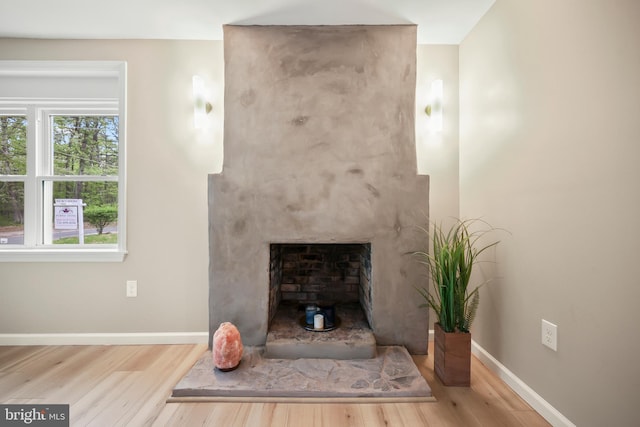 702 Lupin St, Browns Mills, NJ 08015 - unfurnished living room featuring wood finished floors, baseboards, and a large fireplace