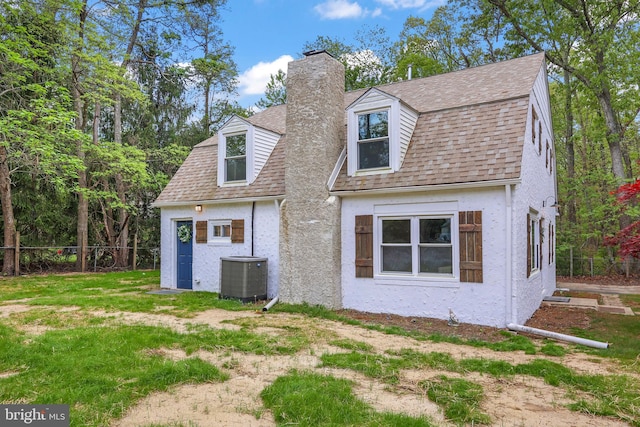 702 Lupin St, Browns Mills, NJ 08015 - rear view of property featuring central air condition unit, a chimney, a shingled roof, stucco siding, and fence