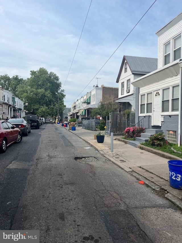 5721 N Lawrence St, Philadelphia, PA 19120 - view of asphalt road featuring a residential view, sidewalks, and curbs