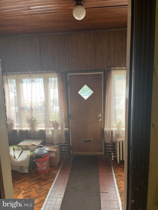 5721 N Lawrence St, Philadelphia, PA 19120 - entryway with wood ceiling, radiator heating unit, and brick patterned floors