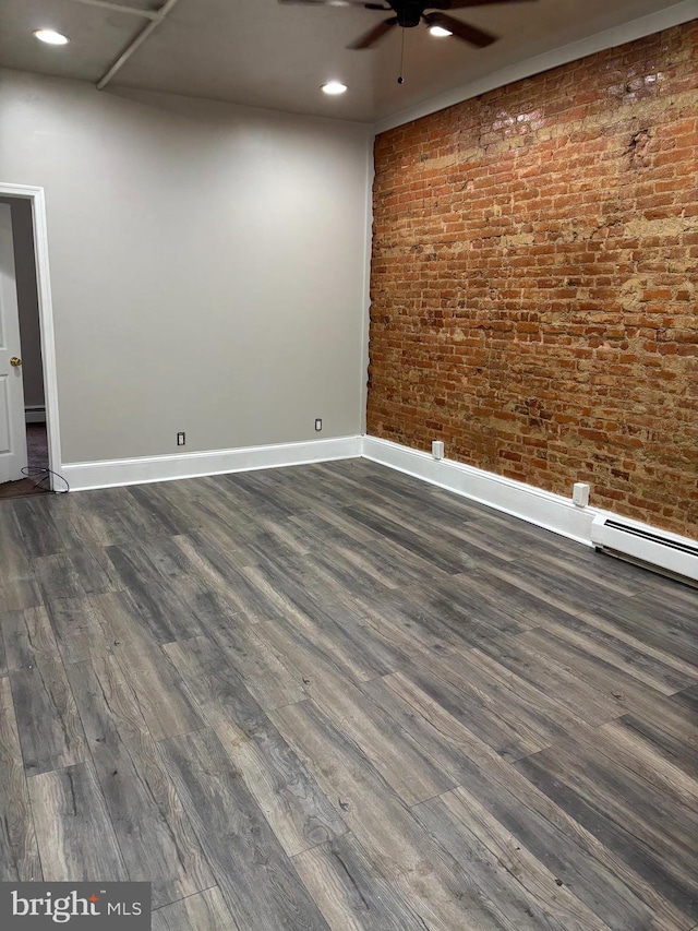 unfurnished room with a ceiling fan, baseboards, dark wood-style flooring, recessed lighting, and brick wall