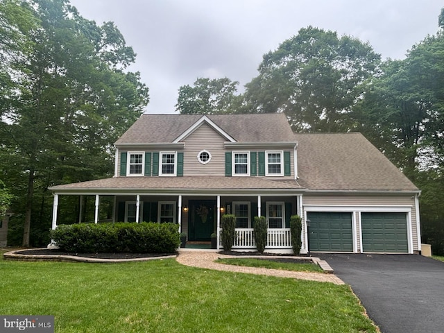 11050 Stonebrook Dr, Manassas, VA 20112 - colonial inspired home with covered porch, an attached garage, asphalt driveway, and a front lawn