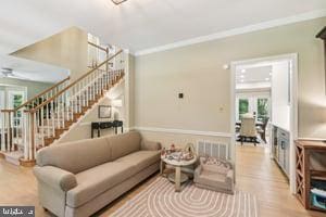 11050 Stonebrook Dr, Manassas, VA 20112 - living area featuring healthy amount of natural light, ornamental molding, stairway, and wood finished floors