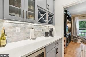 11050 Stonebrook Dr, Manassas, VA 20112 - bar area with backsplash and light wood-style floors