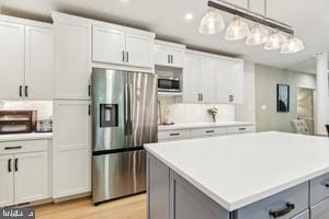 11050 Stonebrook Dr, Manassas, VA 20112 - kitchen featuring appliances with stainless steel finishes, a center island, gray cabinetry, light countertops, and hanging light fixtures