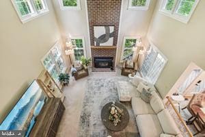 11050 Stonebrook Dr, Manassas, VA 20112 - living room with a towering ceiling, a fireplace, and carpet floors