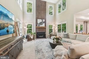 11050 Stonebrook Dr, Manassas, VA 20112 - living area with a high ceiling, plenty of natural light, a large fireplace, and light colored carpet